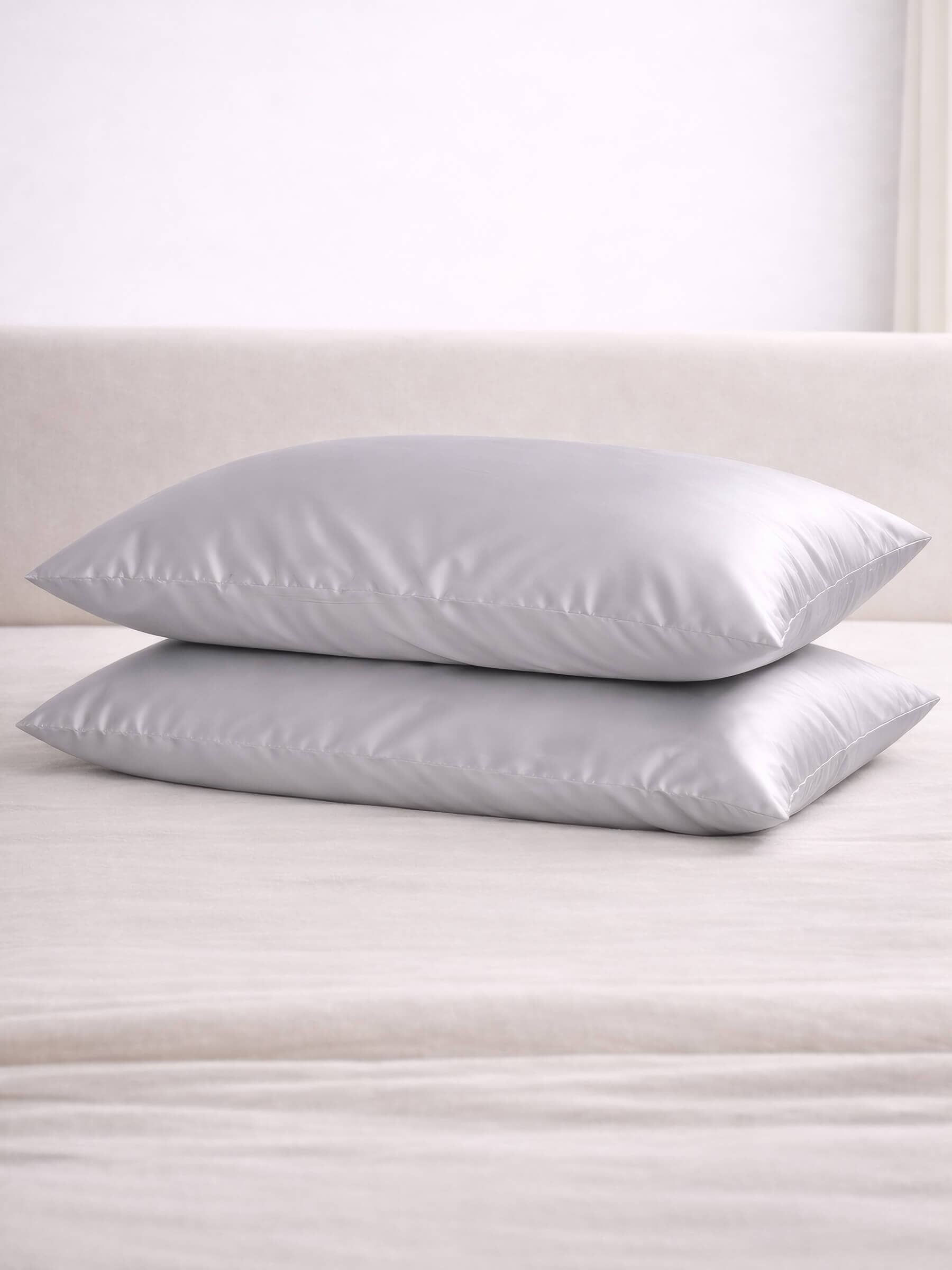 stacked image of two grey silk pillowcases
