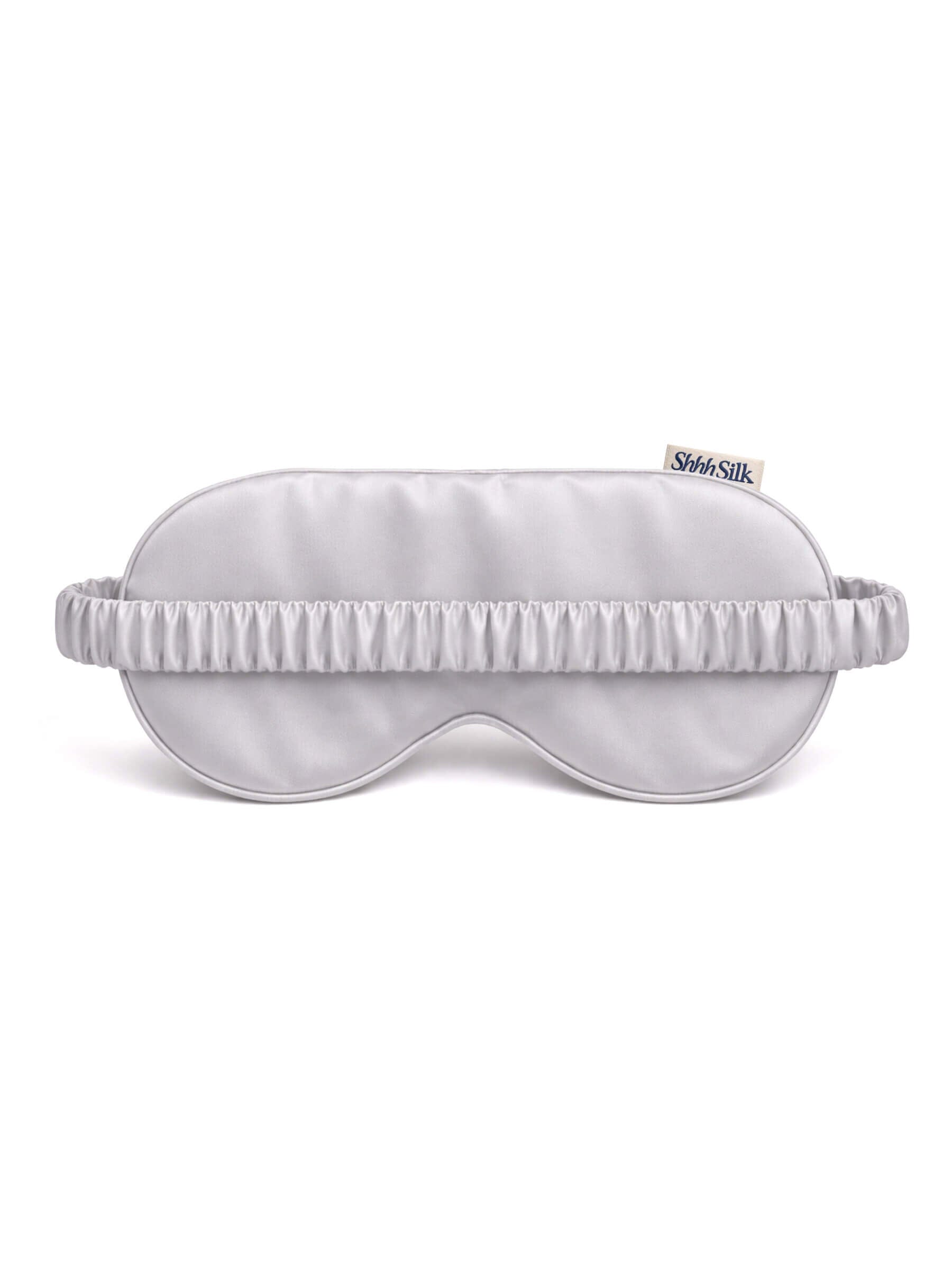 Grey silk sleep mask on a white background