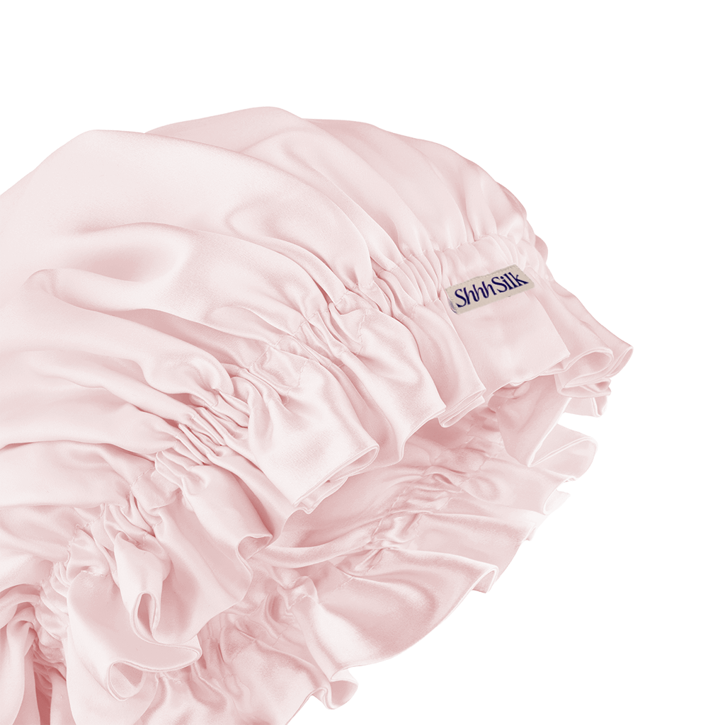A pink silk sleep bonnet