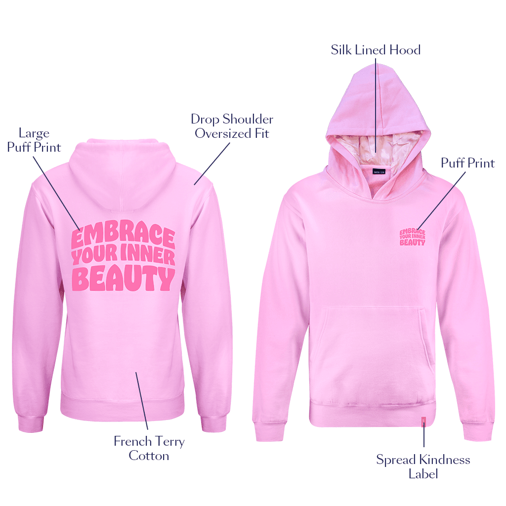 A pink silk-lined hoodie with the text 'EMBRACE YOUR INNER BEAUTY' on the front, showcasing both the hood lined with silk and the hoodie itself with a puff logo on the chest.