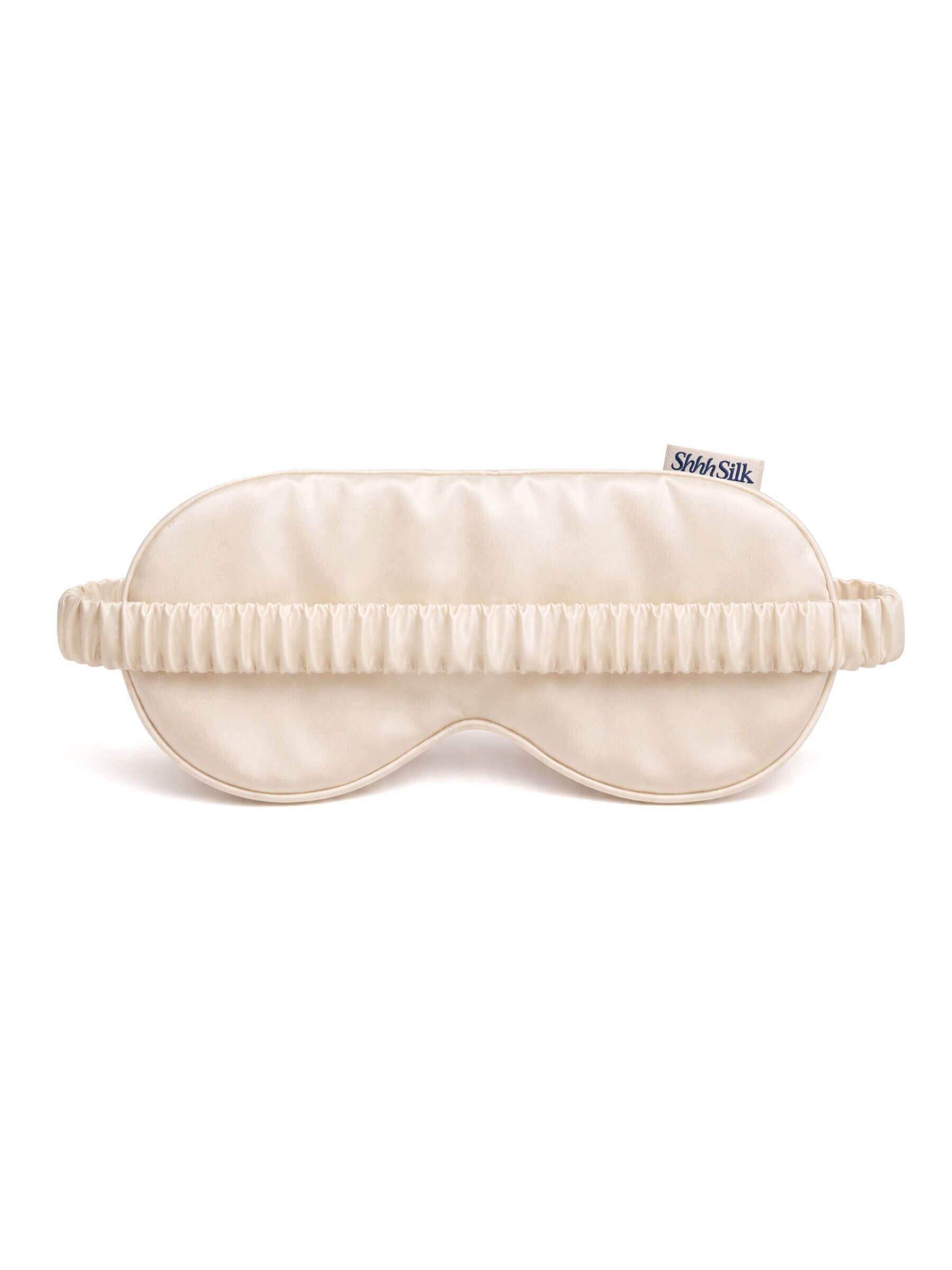 Nude silk sleep mask on a white background